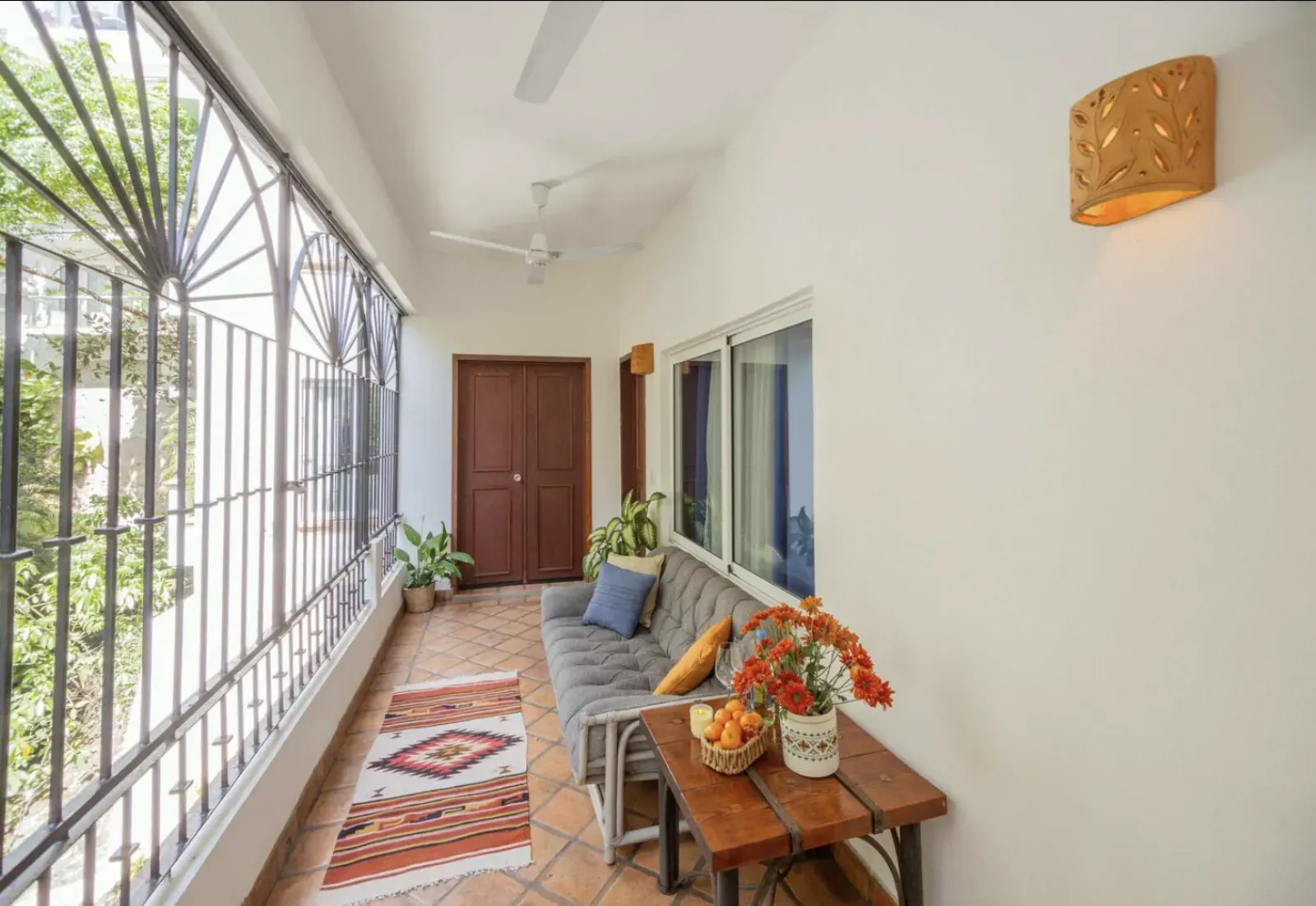 Apartment entrance with balcony and outdoor seating