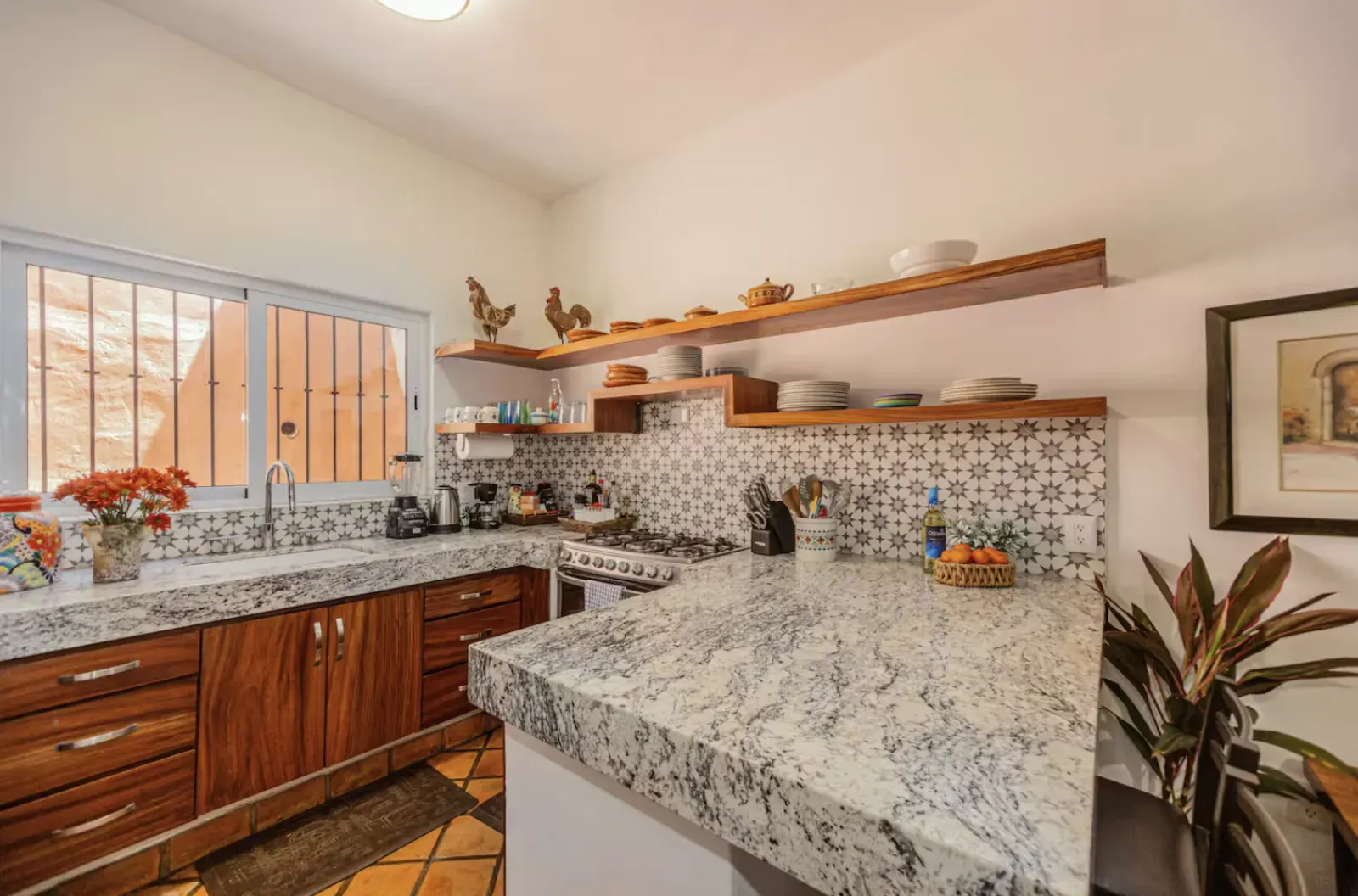 Kitchen with granite bar and wooden shelves